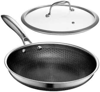 The HexClad 10-inch hybrid nonstick frying pan with lid on a gas range