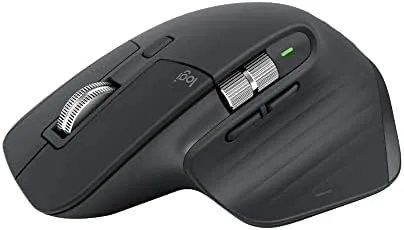 Logitech MX Master 3S graphite mouse on a desk beside a laptop
