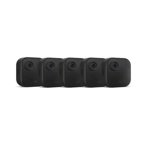 A Blink Outdoor 4 camera mounted on a wall beside a doorway