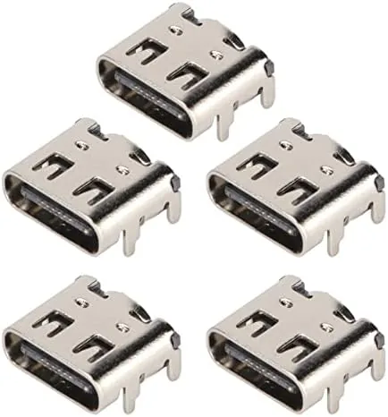 Five USB-C charging port assemblies laid out on a workbench