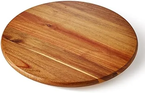 Round acacia wood lazy susan tray on a kitchen counter showing the wood grain
