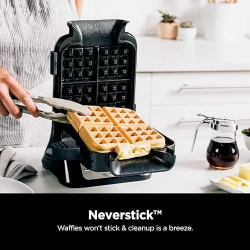 The precision pour cup filled with batter above the waffle maker