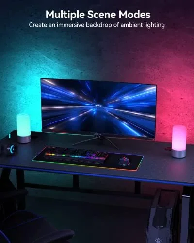 The lamp on a desk next to a laptop in the evening