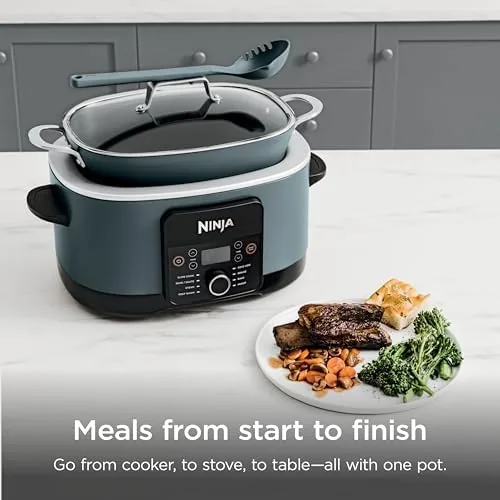 A pot roast cooking inside the PossibleCooker PRO with the glass lid on