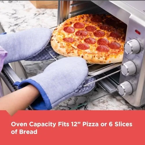 The removable crumb tray sliding out from the bottom of the toaster oven