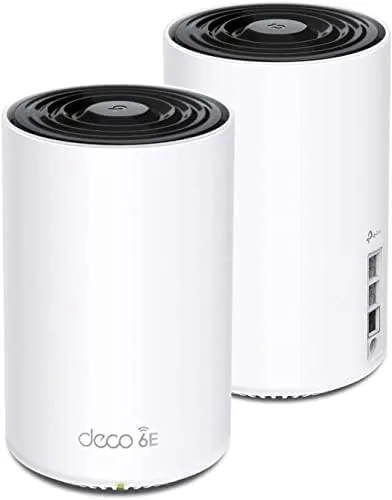 Two TP-Link Deco XE75 Pro units placed in a living room on a shelf