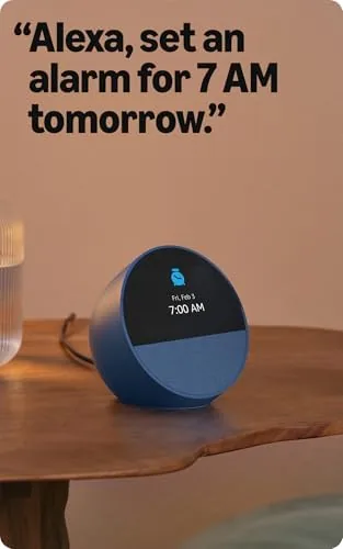 Echo Spot on an office desk beside a laptop