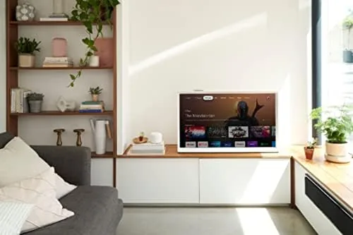The Chromecast dongle tucked behind a wall mounted television