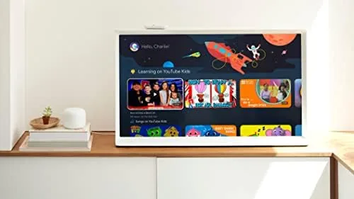 The Chromecast remote in hand with the voice search button pressed