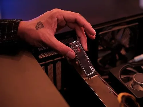The 990 PRO packaging and the drive laid out with the Samsung Magician software on a screen