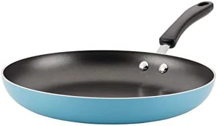 The Farberware Cookstart 12.25 inch skillet in aqua resting on a stovetop