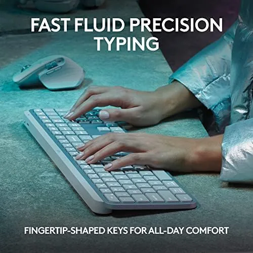 Pale grey keyboard backlit in a dim room