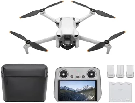 The DJI Mini 3 hovering in flight against a bright sky