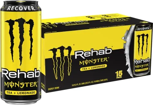 Monster Rehab Tea Lemonade can on a picnic table with a glass