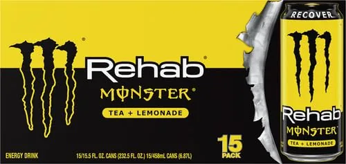 Monster Rehab Tea Lemonade can on a desk beside a laptop in an office