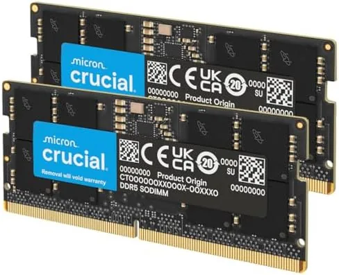 Two Crucial 32GB DDR5 SODIMM modules side by side on a desk