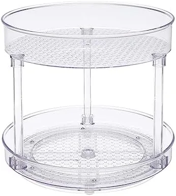 The two-tier clear lazy susan loaded with spice jars on a pantry shelf