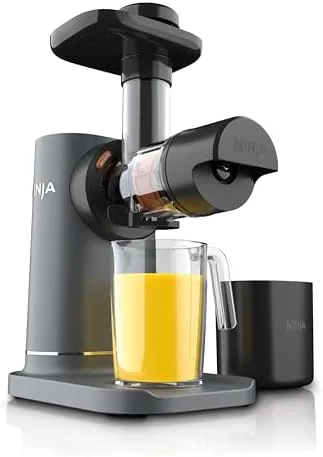 The Ninja NeverClog cold press juicer on a kitchen counter with a filled jug