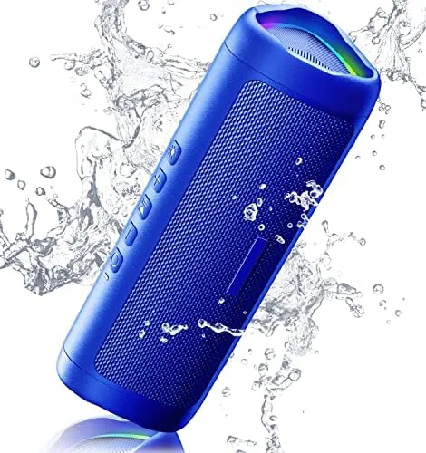The blue 20W Bluetooth speaker on a patio table with a clear sky behind