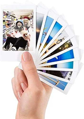 A collection of developed Instax Mini prints spread on a table