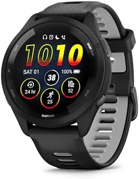 Garmin Forerunner 265 in black and powder gray showing a dark watch face on a desk