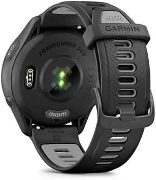The Forerunner 265 on a wrist during a run with a river and trees in the background
