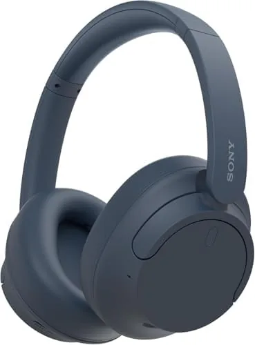 Blue Sony WH-CH720N headphones resting on a table with a cup of coffee nearby