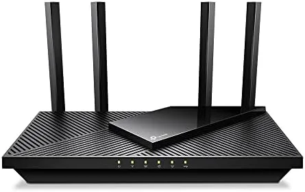 TP-Link Archer AX55 Pro router standing on a desk with antennas upright
