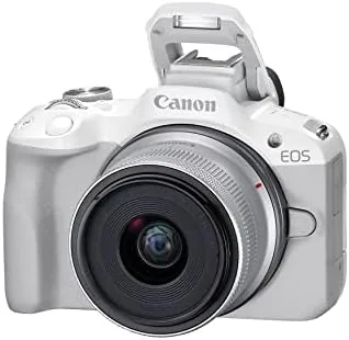 Test bench with the white EOS R50, spare battery, and memory cards