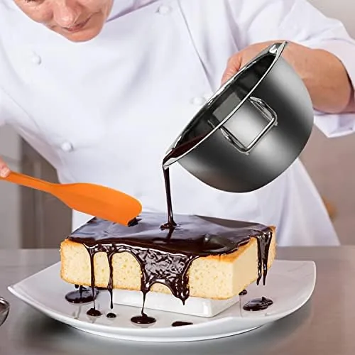Melted chocolate in the upper pot above steaming water in the lower pot