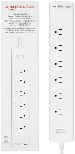 The Amazon Basics smart power strip lying on a desk with six outlets visible