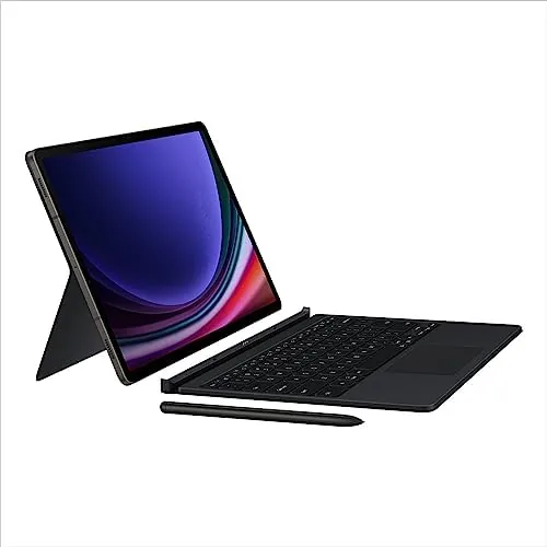 Full desk setup with the Tab S9+ docked, monitor, and laptop nearby