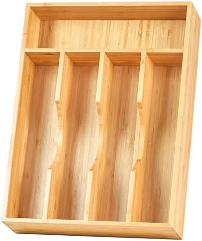 The bamboo drawer organizer sitting inside a small kitchen drawer with cutlery in place