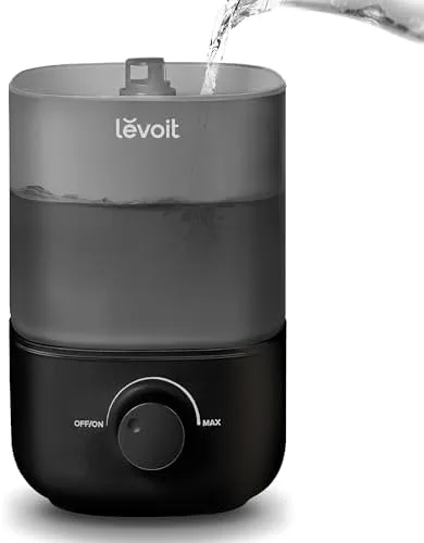 The Levoit top-fill humidifier sitting on a nightstand in a bedroom