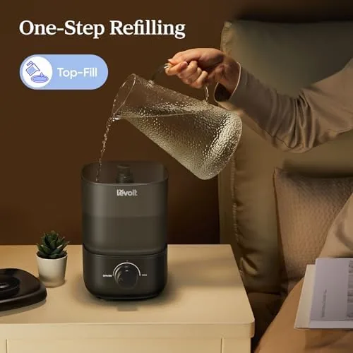 Water being poured directly into the top-fill reservoir of the humidifier