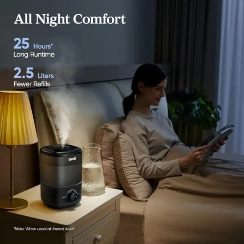 The humidifier running on a nightstand with a hygrometer showing rising humidity