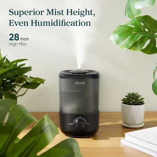 The Levoit humidifier next to a larger evaporative humidifier for comparison