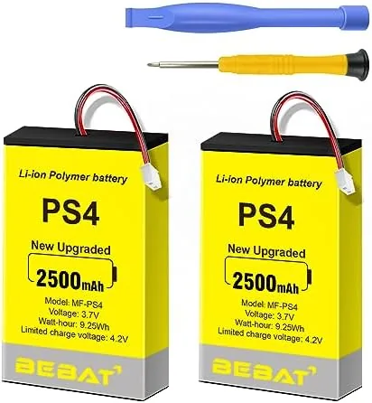 Two PS4 controller battery packs with the included tool kit laid out on a desk