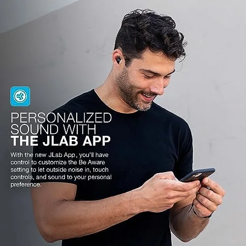 JLab JBuds Mini compared in hand with a standard pair of wireless earbuds