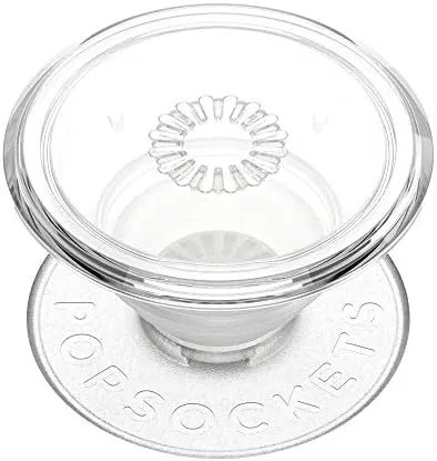 A Kindle propped on a table with the PopGrip popped open as a stand