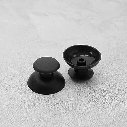 Two PS3 controllers side by side, one with new caps and one with worn sticks