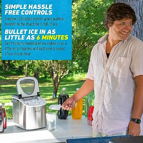 A glass of iced tea filled with bullet ice cubes beside the running ice maker