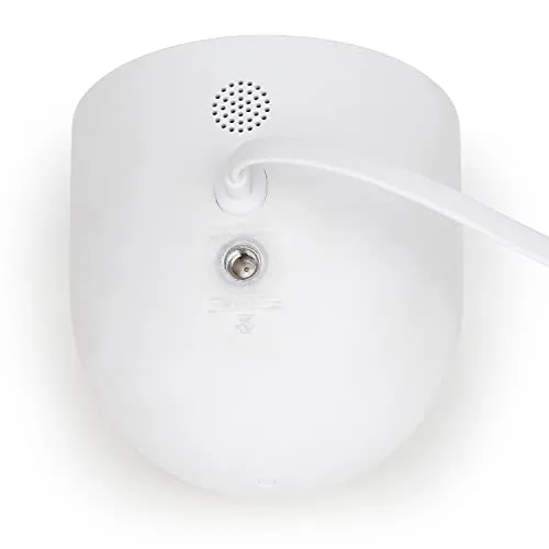 A Nest Cam under the eave with the white cable running cleanly down the wall