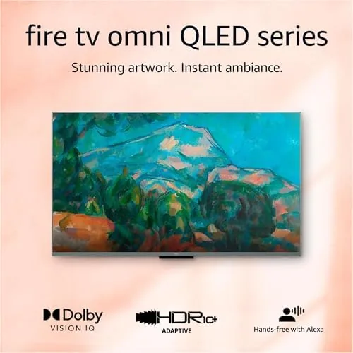 The 50 inch Fire TV Omni QLED mounted on a wall in a dim living room
