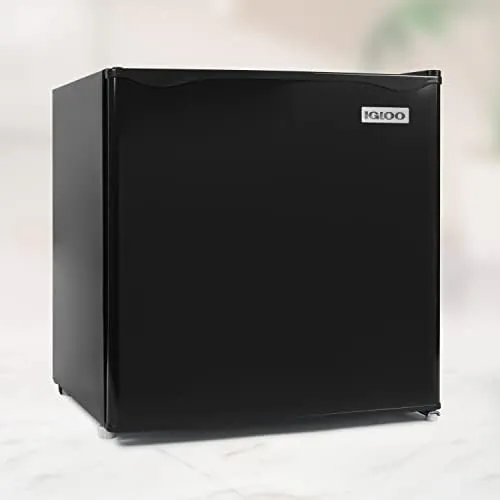 Igloo mini fridge stocked with drinks on a bedroom desk
