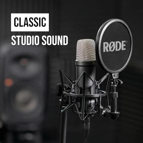 The microphone set up on a desk in front of a laptop for a podcast session