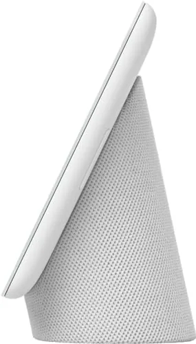 The Nest Hub on a nightstand in dim light showing a clock display