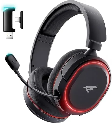 The wireless gaming headset sitting on a desk beside a PC and a USB dongle