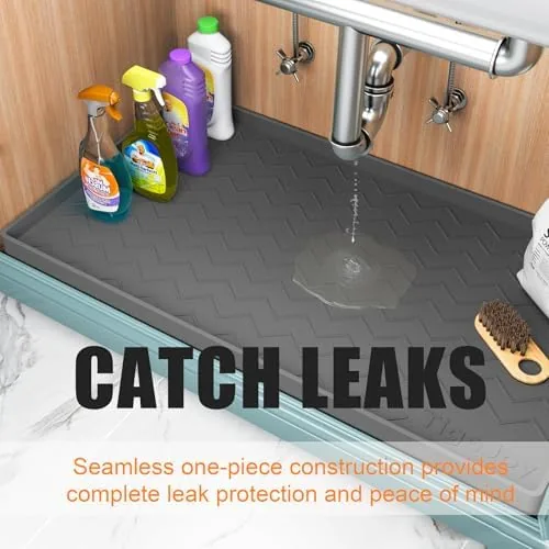 The mat being rinsed under a faucet showing the water beading off