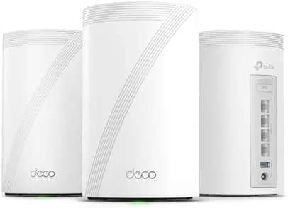 Three TP-Link Deco 7 Pro nodes arranged on a table with their boxes